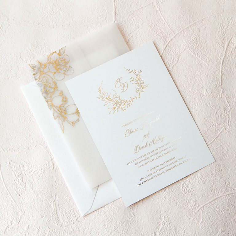 Gold foil vellum wrap invitation with delicate flowers